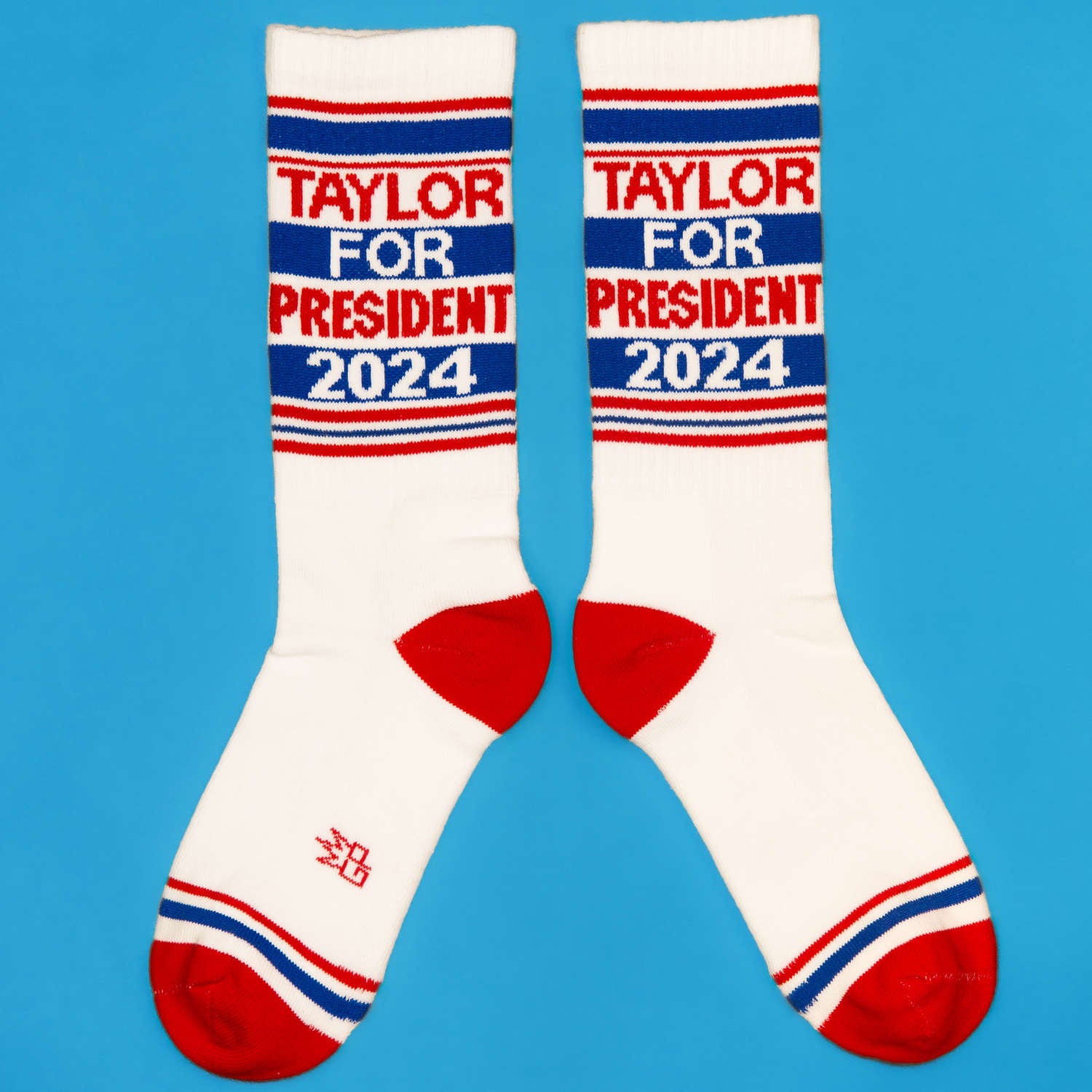 Close-up view of 'Taylor for President 2024' socks, showing details. [lf]