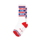 Pair of white crew socks with red, white, and blue stripes and 'Taylor for President 2024' text.