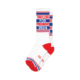 close up, front view of white socks with red and blue stripes and "taylor for president 2024" printed on them.