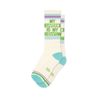 Pair of off-white crew socks with a green 'My Garden Is My Therapist' design and light purple and teal stripes.