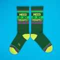 Flatlay product shot showing two 'Weed Is My Therapist' socks on a bright blue background. [lf]