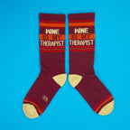 Another view of the socks on a blue background, showcasing the design. [lf]