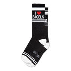 Pair of black crew socks with a white and red 'I Heart Bagels' design.  Features white stripes and a subtle sparkly texture.