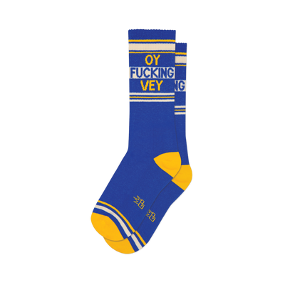 Pair of blue crew socks with yellow and white stripes and the phrase 'OY FUCKING VEY' in yellow lettering.