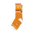 Pair of mustard yellow crew socks with horizontal stripes that say 'Beer' in a retro style font.  White and orange accents.