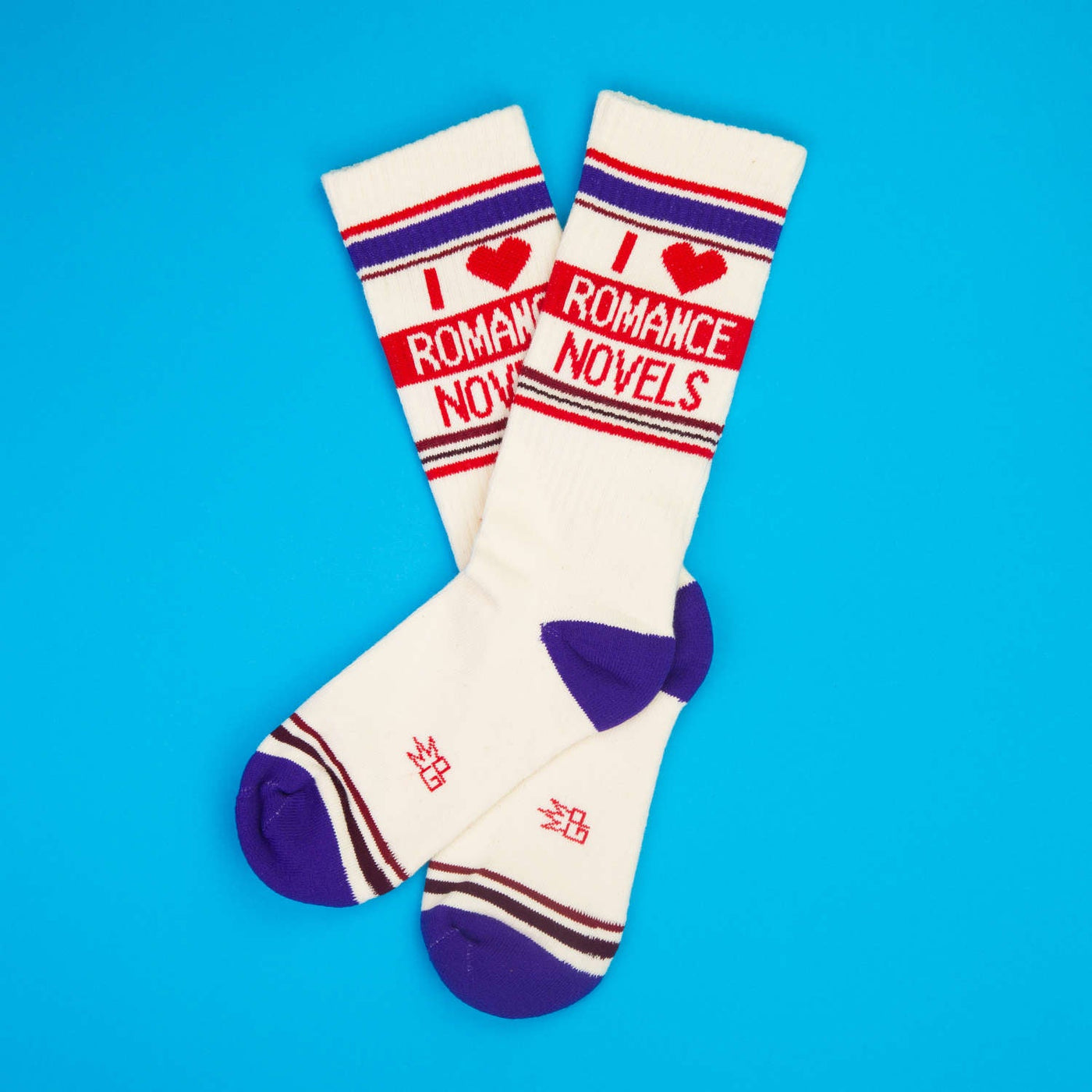Flatlay of a pair of 'I Heart Romance Novels' socks on a blue background.