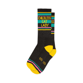 front view of two black socks with yellow, pink, and teal stripes that read 'childless cat lady'.