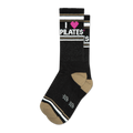 Pair of black crew socks with taupe stripes and a pink heart; 'I heart Pilates' is written on the socks.