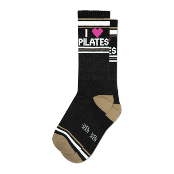 Pair of black crew socks with taupe stripes and a pink heart; 'I heart Pilates' is written on the socks.