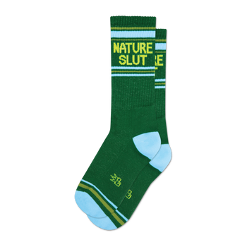 A pair of dark green crew socks with a light blue cuff and yellow 'NATURE SLUT' text.  Features thin yellow and olive green stripes.