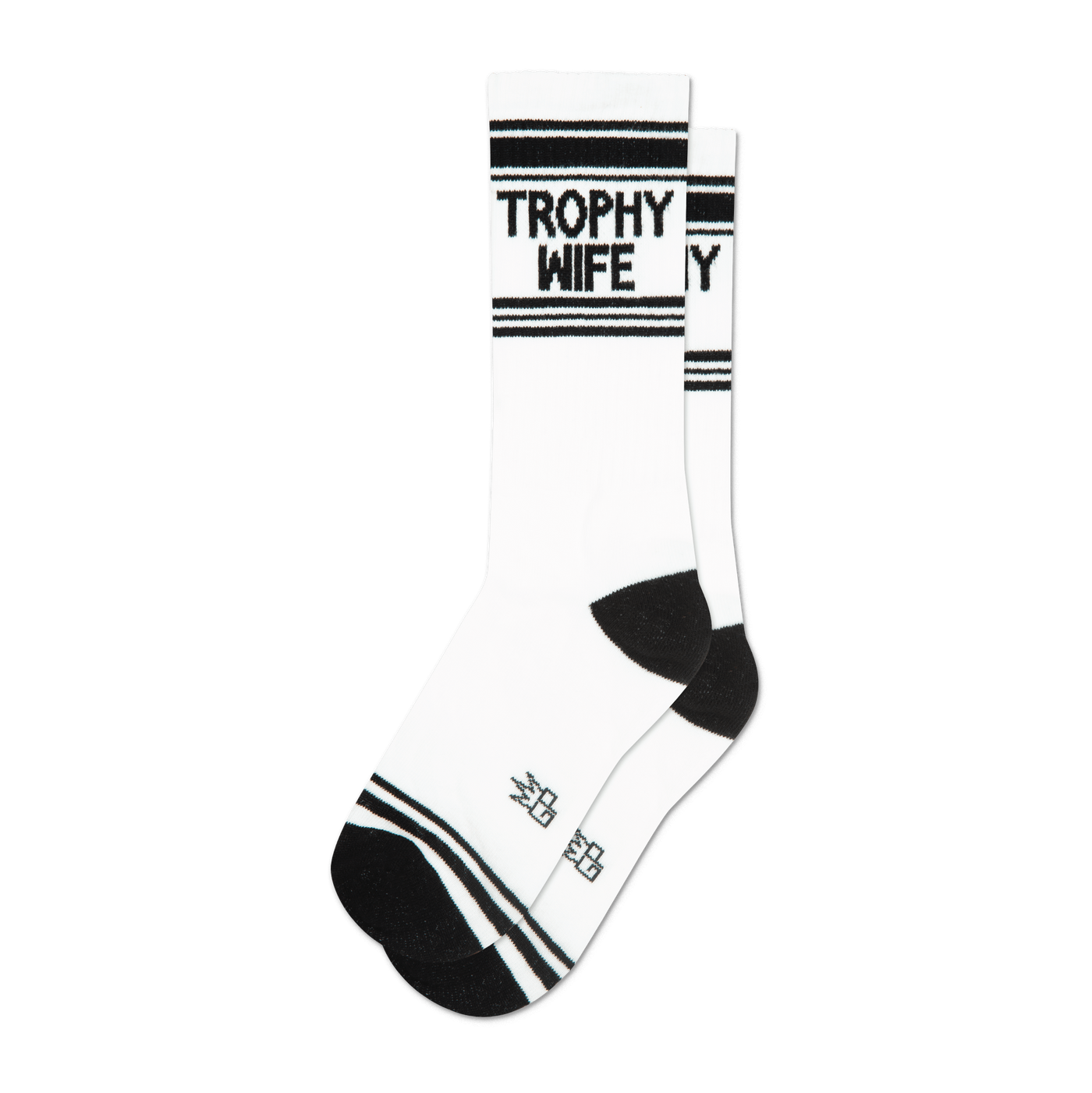 A pair of white crew socks with black stripes and the words 'Trophy Wife' in black.  The socks have a black heel and toe.