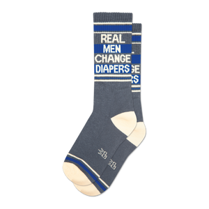 Pair of grey crew socks with blue stripes and the text 'Real Men Change Diapers'.