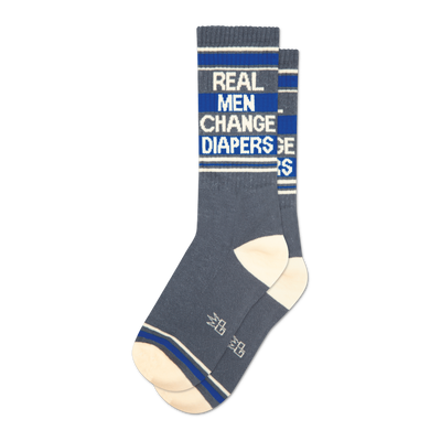 Pair of grey crew socks with blue stripes and the text 'Real Men Change Diapers'.
