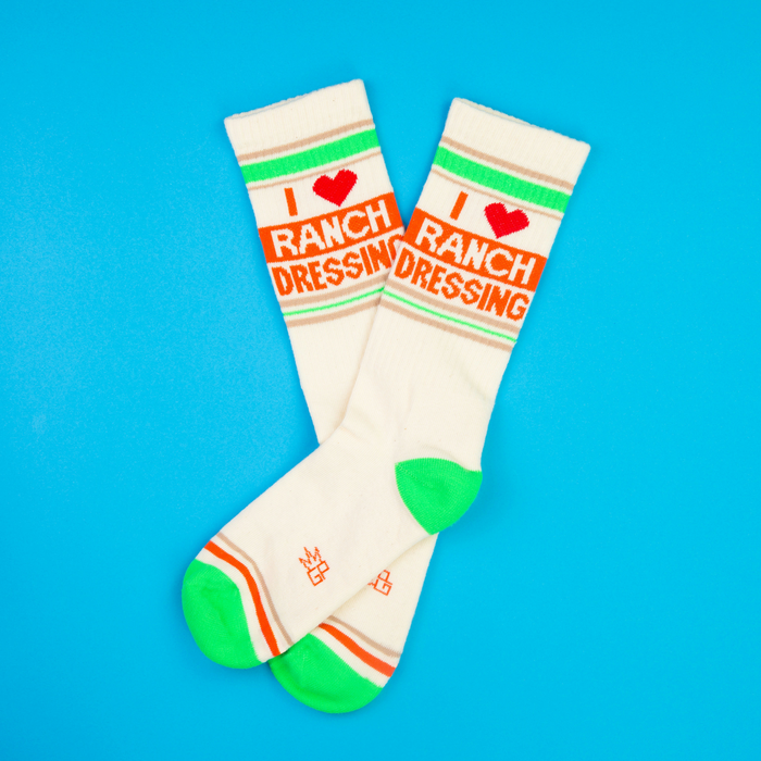 Flat lay of 'I Heart Ranch Dressing' crew socks on a bright blue background.