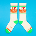 Another flat lay product shot showcasing the socks' design, showcasing both socks fully against a blue background.