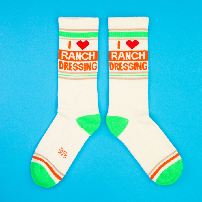 Another flat lay product shot showcasing the socks' design, showcasing both socks fully against a blue background.