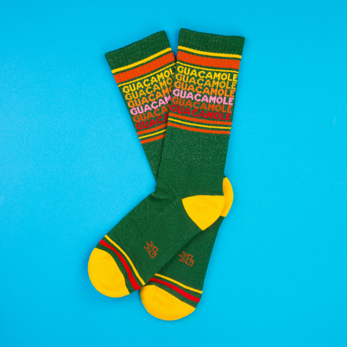 Another flat lay of Guacamole socks on a bright blue background, slightly different angle.