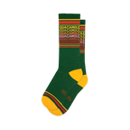 Pair of green crew socks with a repeating 'Guacamole' pattern in yellow, red, and pink. Yellow and red stripes at the top and bottom.