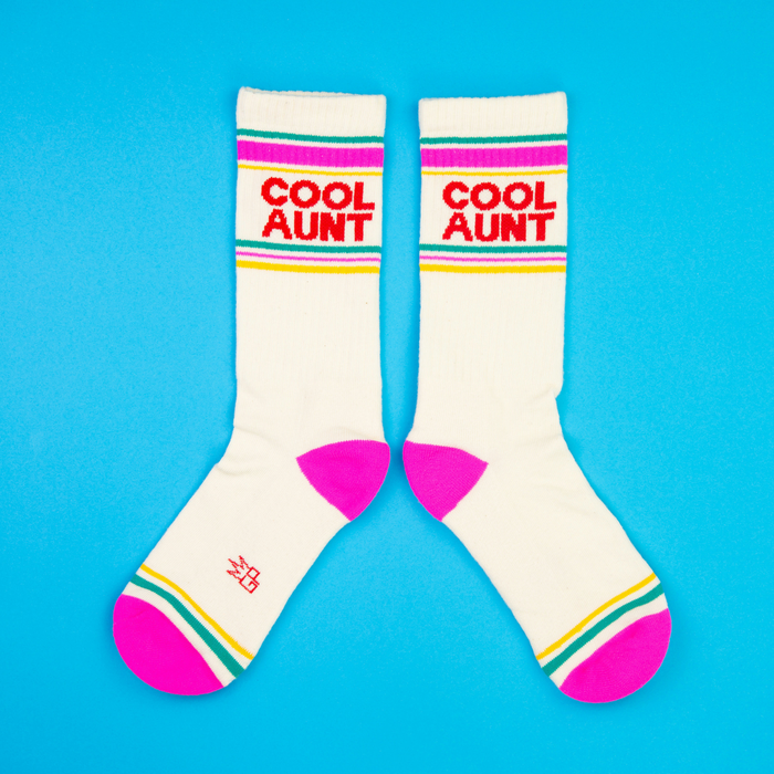 Flatlay photo of a pair of 'Cool Aunt' socks on a bright blue background.