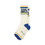 Pair of off-white crew socks with navy blue and gold stripes, featuring 'COOL UNCLE' text.