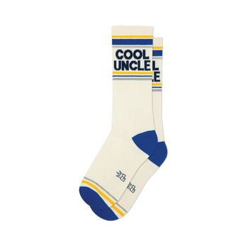 Pair of off-white crew socks with navy blue and gold stripes, featuring 'COOL UNCLE' text.