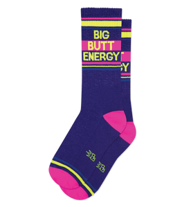 Pair of purple crew socks with neon pink and yellow stripes and the words 'BIG BUTT ENERGY' printed on them.
