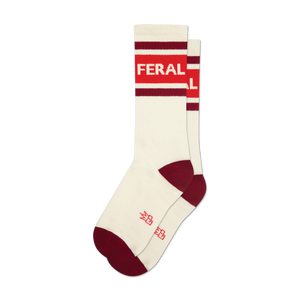 Pair of cream-colored crew socks with red and burgundy stripes and the word 'FERAL' in bold white lettering.