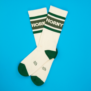 Flatlay of a pair of 'Horny' socks on a bright blue background.
