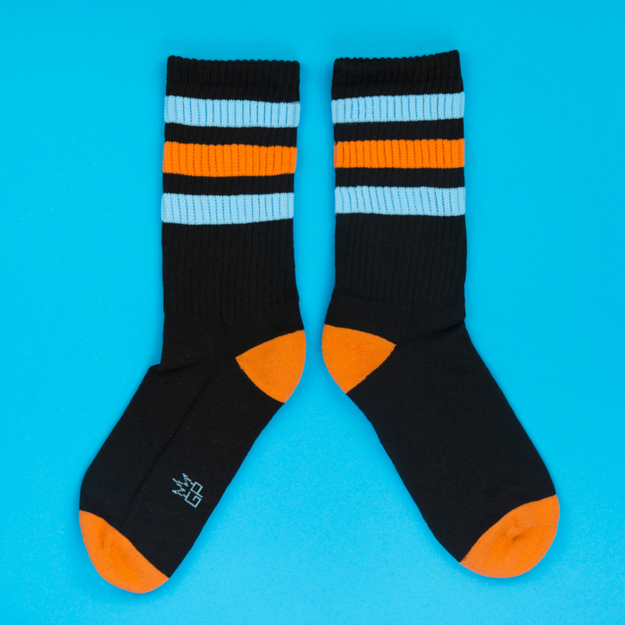 Another flat lay showcasing a pair of Astro Retro socks, this time arranged to show both socks fully.