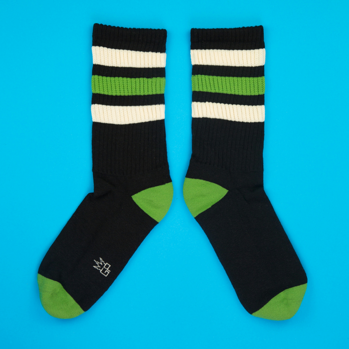 Flatlay product shot of Elroy Retro socks on a bright blue background, showing the full sock design.