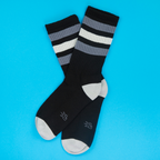 Flatlay product shot of George Retro socks against a bright blue background.