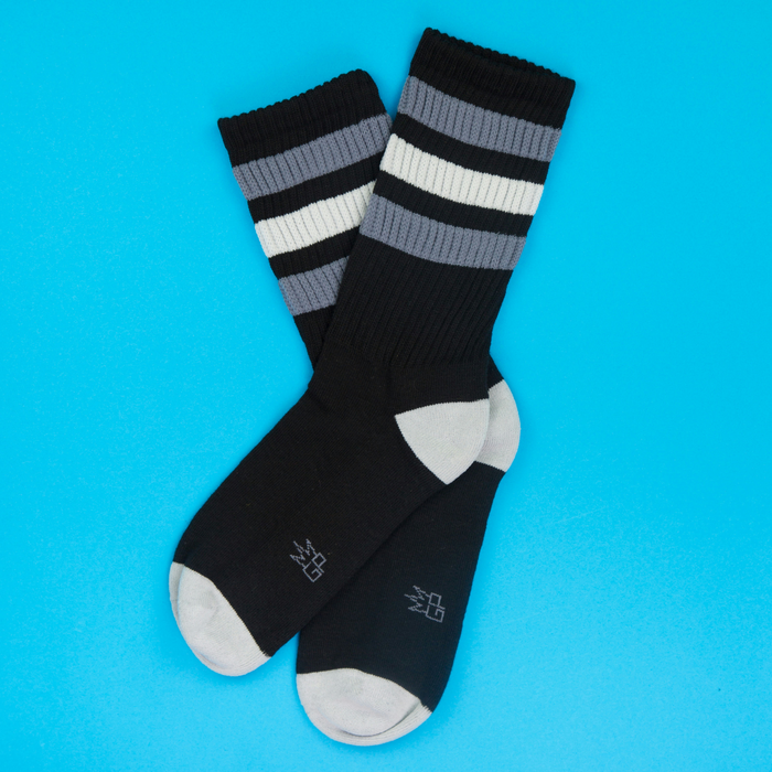 Flatlay product shot of George Retro socks against a bright blue background.