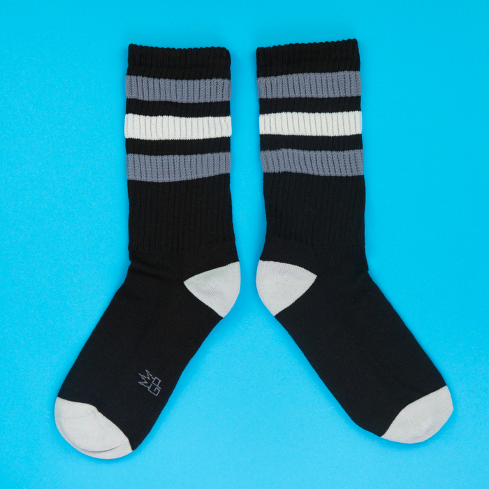 Another flatlay product shot showcasing the George Retro socks, arranged differently against a bright blue background.