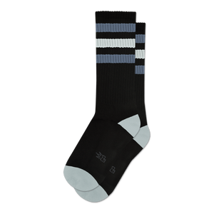 Pair of black crew socks with grey and white stripes.  Features a light grey toe and heel, and a small logo on the sole.