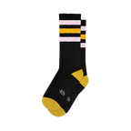 Pair of black crew socks with pink and gold retro stripes. Yellow heel and toe. 