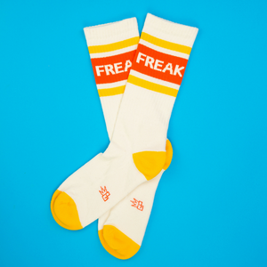 Flat lay of 'Freak' socks on a bright blue background. Shows the sock's full design and color.
