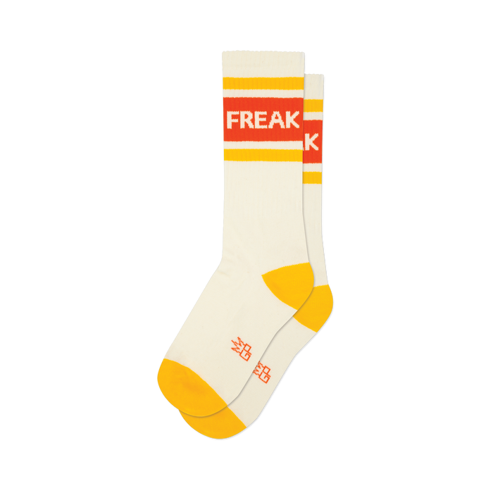 Pair of cream crew socks with orange and yellow stripes and the word 'FREAK' displayed.  A fun, retro design.