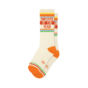 Pair of cream-colored crew socks with orange, red, yellow, and green stripes and the text 'Employee of the Year'.