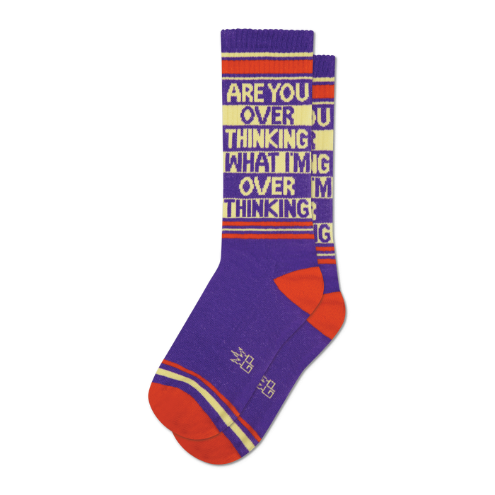 Pair of purple crew socks with orange and beige stripes and the text 'ARE YOU OVER THINKING WHAT I'M OVER THINKING' repeated.