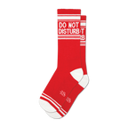 Pair of red crew socks with a white 'Do Not Disturb' message and white stripes. Small logo near the toes.