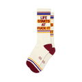 Pair of cream crew socks with maroon, gold, and purple stripes and the phrase 'Life Starts At Fuck It' in a retro font.