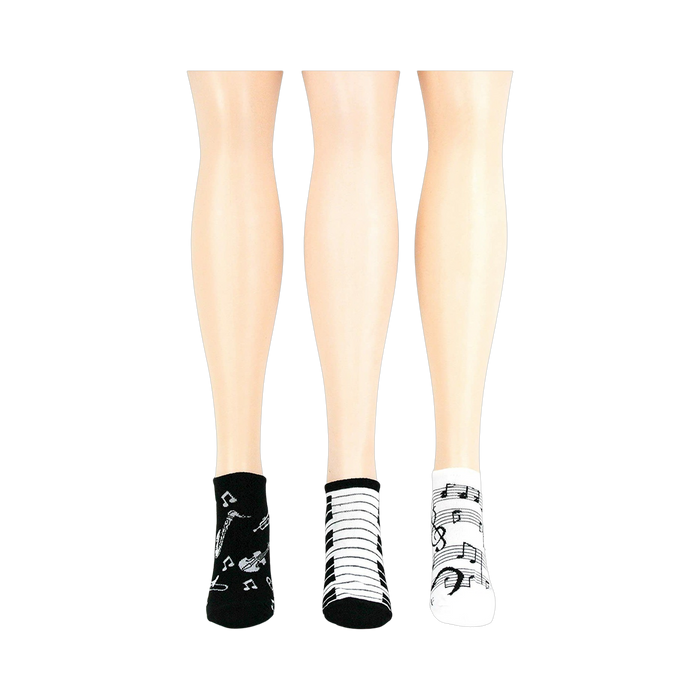 Lifestyle shot: another different angle showing three pairs of musical socks on mannequin legs.