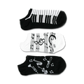 Three pairs of ankle socks; one black with musical instruments, one black and white piano keys, and one white with musical notes.
