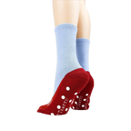 Flatlay showcasing both socks, highlighting the red slipper design and non-skid dots on the bottom.