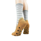 Back view of the socks highlighting the non-skid grips and the tan moccasin design.
