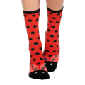 Red crew socks with black polka dots, a black cuff, and a ladybug face with eyes and antennas designed on the toe.