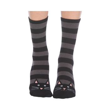 A pair of gray and black striped crew socks with cute black cat faces at the toes. Non-skid bottom.