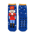 Blue crew socks featuring a Nutcracker design, snowflakes, and non-skid grips on the soles. Red, gold, and white accents.