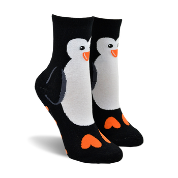 Pair of black ankle socks featuring a white penguin design on the front and orange hearts on the toes.