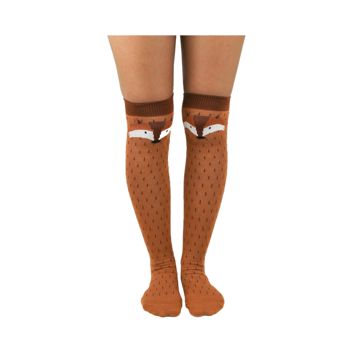 A pair of brown knee-high socks with cute fox faces on the calf area. The socks have a subtle textured pattern. }}
